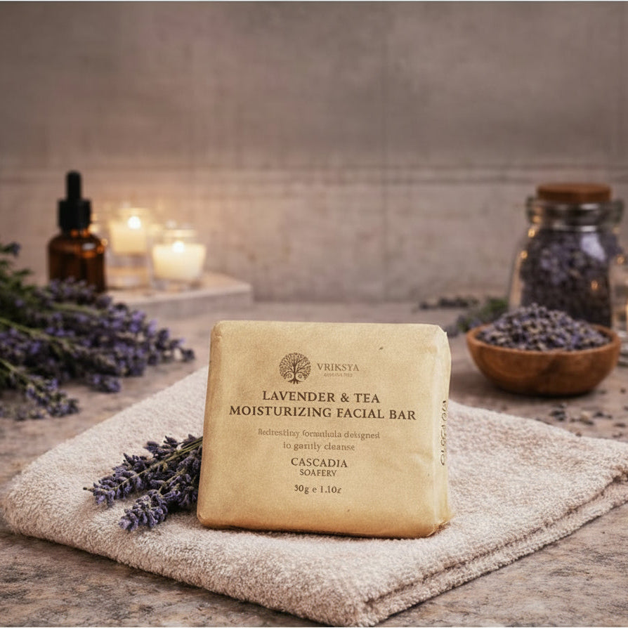 Lavender and tea moisturizing facial bar on a towel with lavender flowers and candles in the background