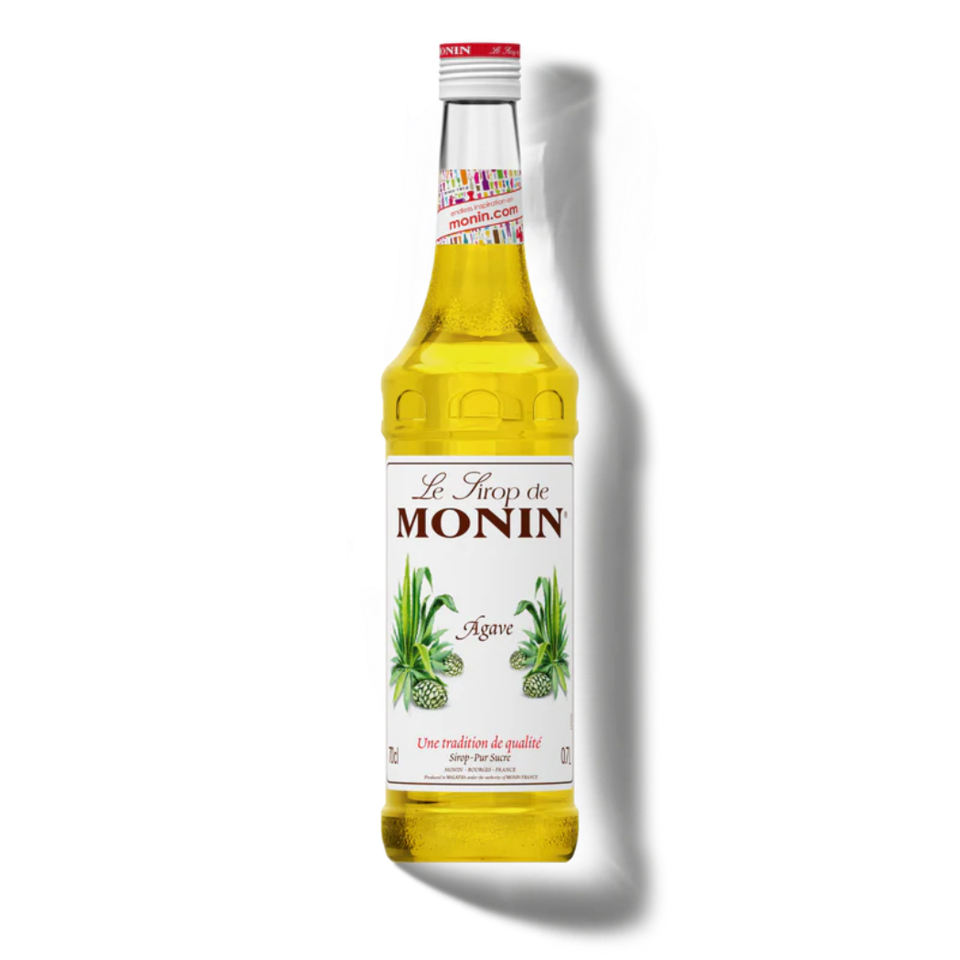 Bottle of Monin agave syrup on a white background