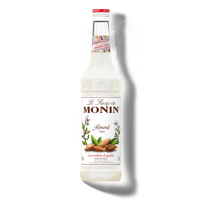 Monin almond syrup bottle on a white background
