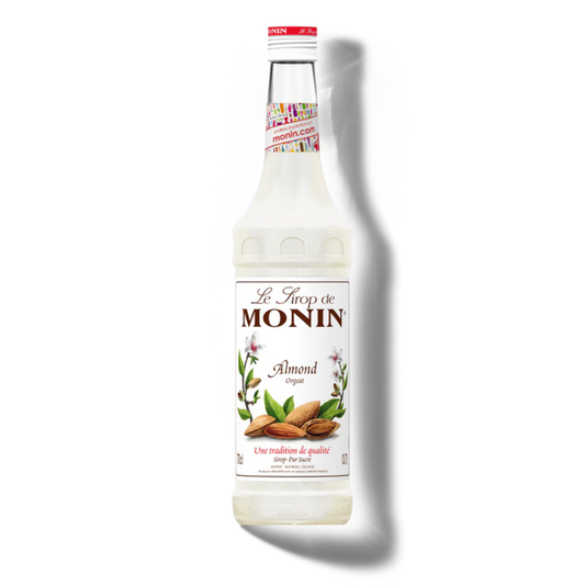 Monin almond syrup bottle on a white background