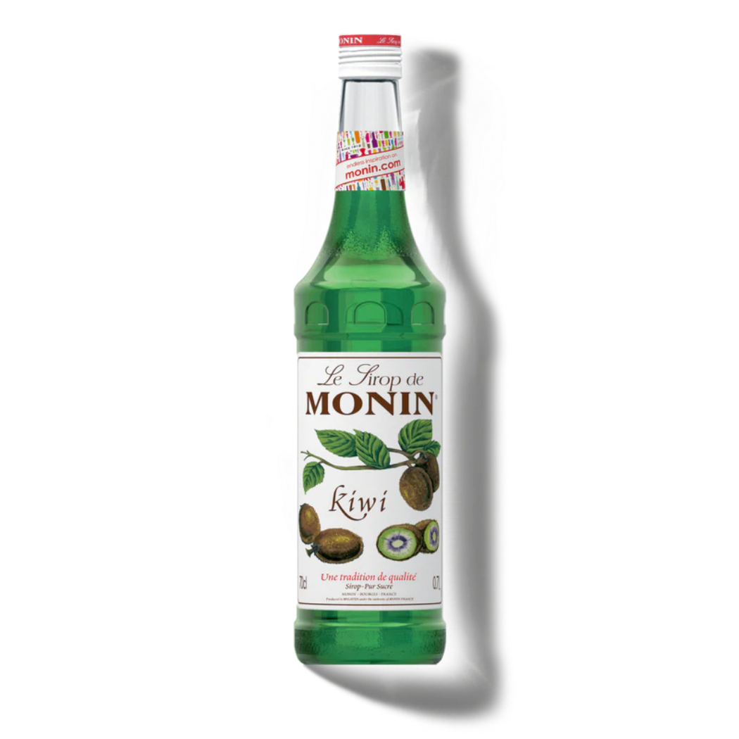 Green bottle of Monin kiwi syrup on a white background