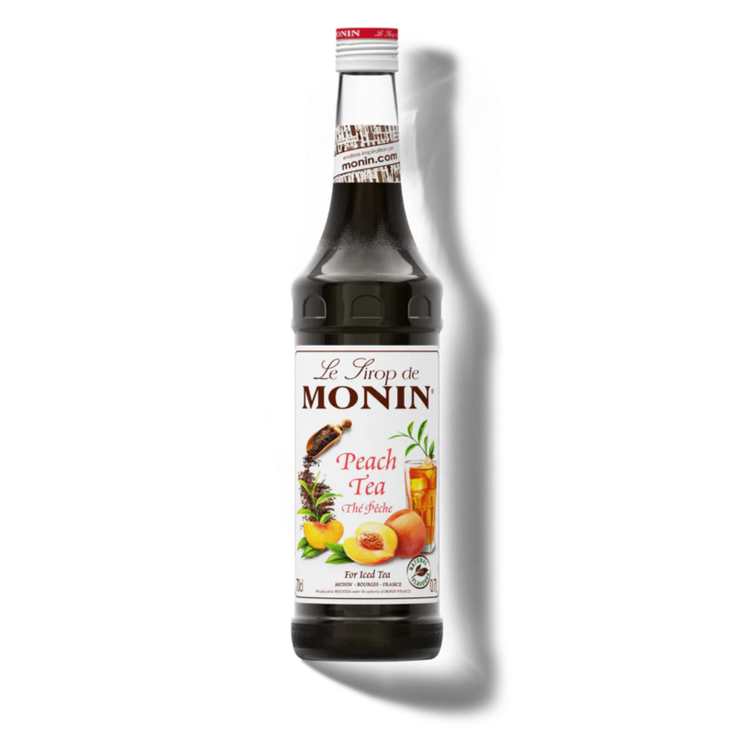 Monin Peach Tea syrup bottle on a white background