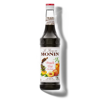 Monin Peach Tea syrup bottle on a white background
