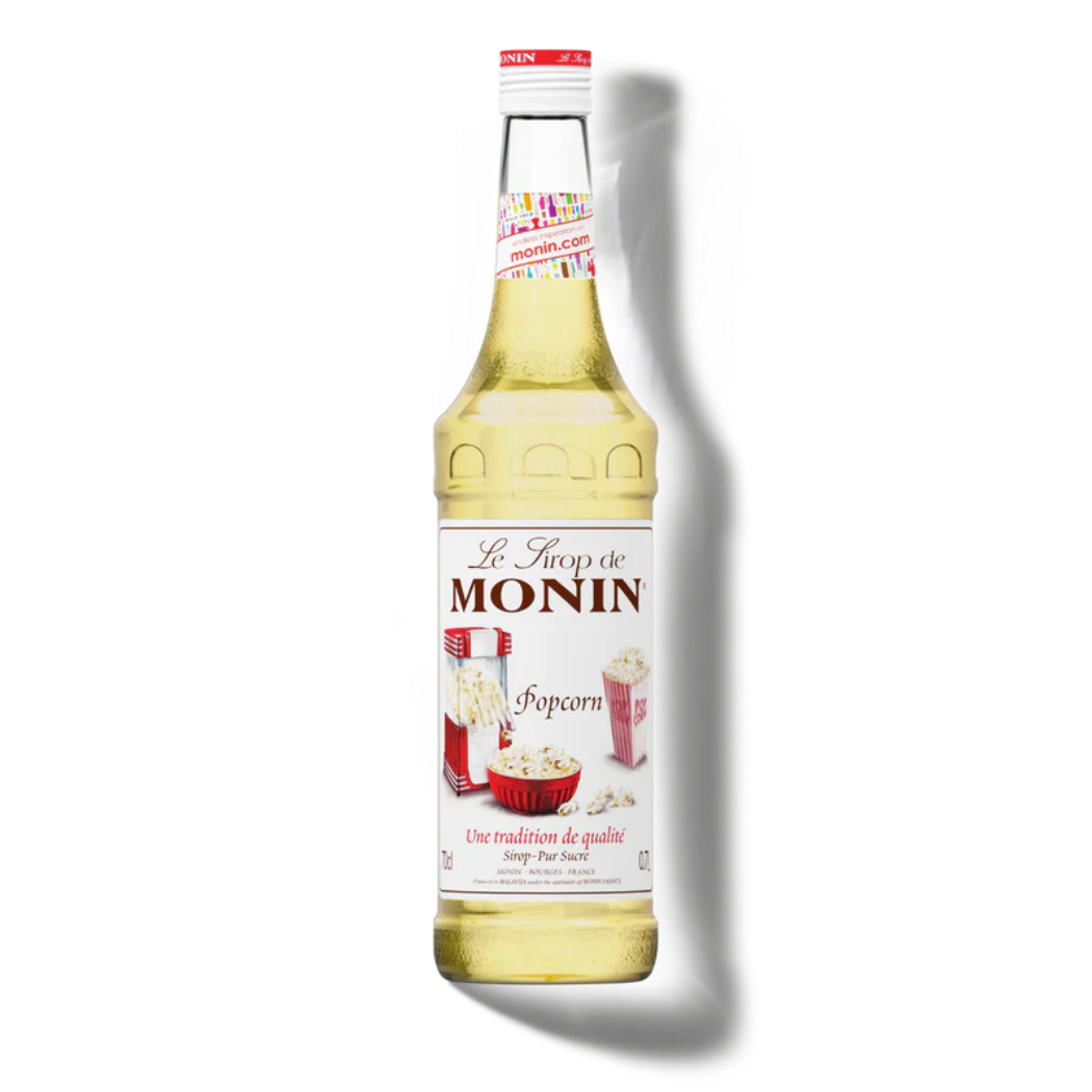 Monin popcorn syrup bottle on a white background