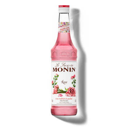 Pink Monin syrup bottle on a white background