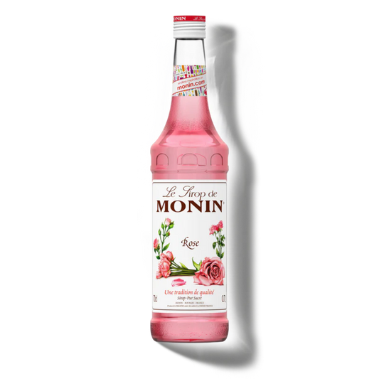 Pink Monin syrup bottle on a white background