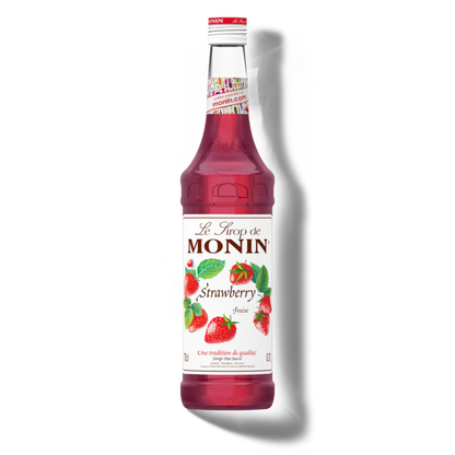 Bottle of Monin strawberry syrup on a white background
