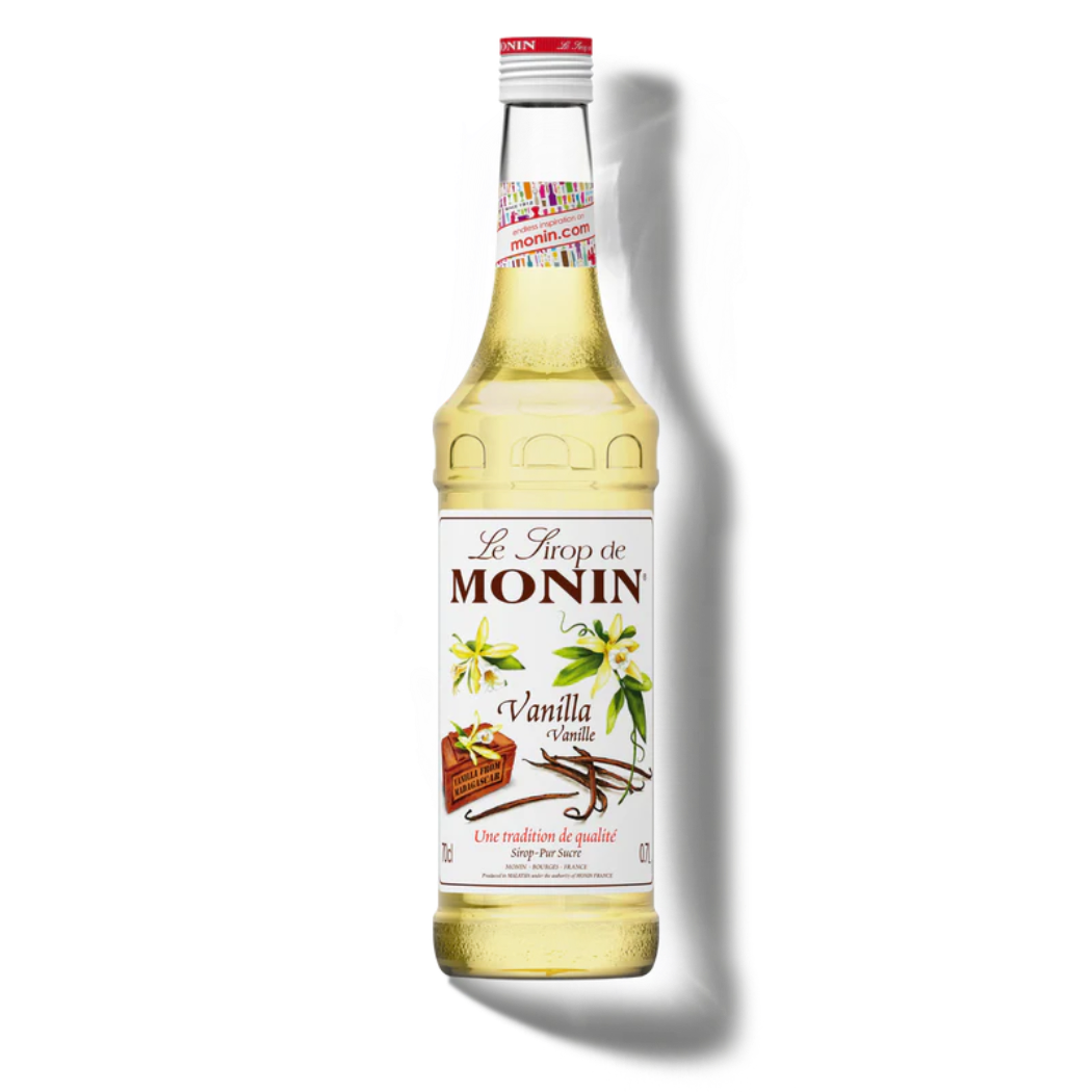 Monin vanilla syrup bottle on a white background