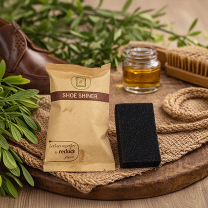 Shoe shining kit with a packet, brush, and jar on a wooden surface.